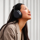 The Sennheiser Momentum 4 wireless headphones being worn.
